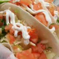 Fish Tacos · Three flour tortillas with tilapia, lettuce, tomatoes, cheese & sour cream with a side of ri...