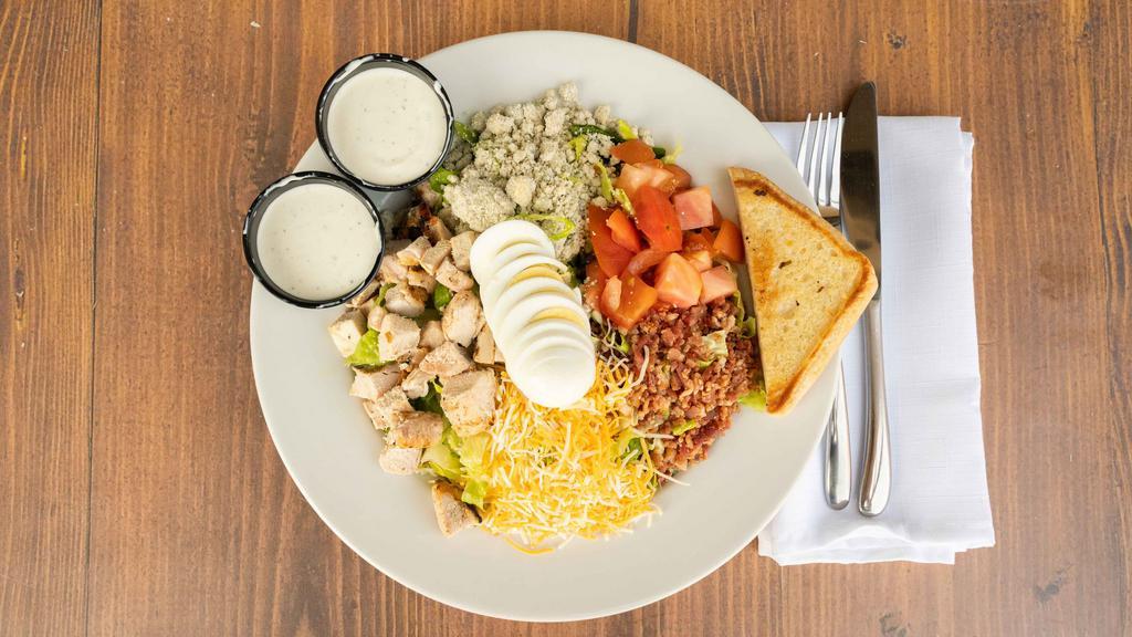 Cobb Salad · Romaine lettuce, chilled charbroiled chicken breasts, bleu cheese crumbles, bacon, tomatoes, egg, mixed cheese and your choice of dressing