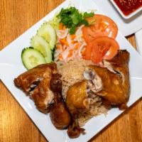 Com Ga · Ginger fried rice with two pieces of fried quarter leg chicken served with a side of lettuce...