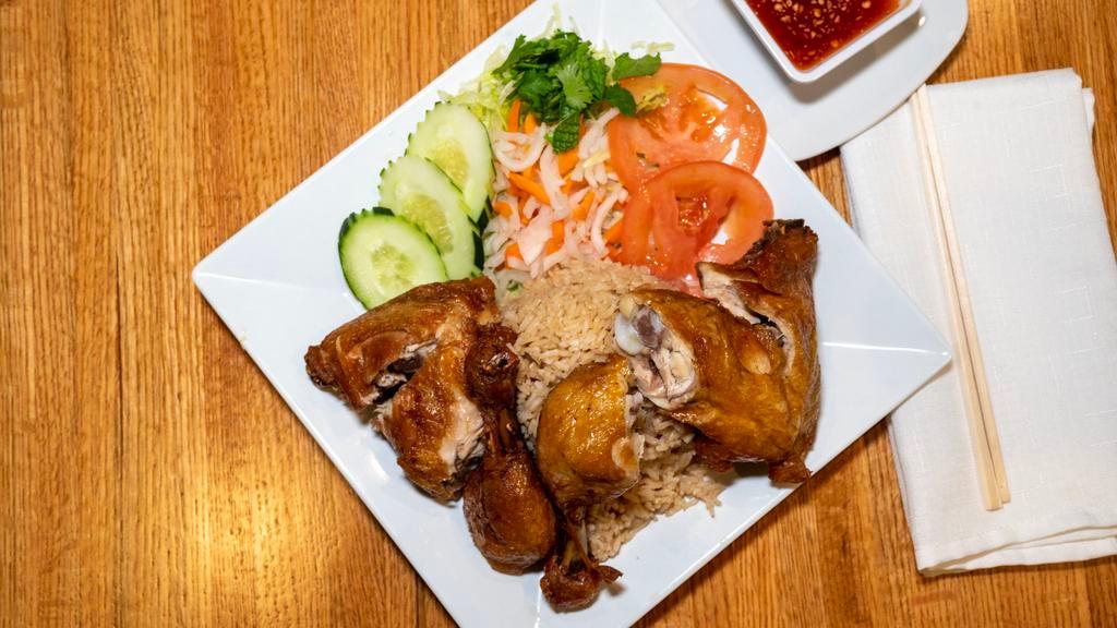 Com Ga · Ginger fried rice with two pieces of fried quarter leg chicken served with a side of lettuce, pickled daikon and carrots, cucumber and a side of special spicy ginger sauce.