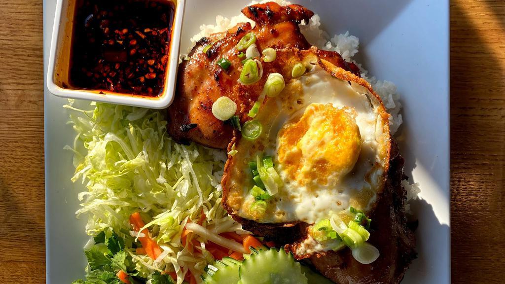 Grilled Chicken Rice Platter · Grilled chicken over broken rice, served with a side of lettuce, pickled daikon and carrots. Topped with a fried egg, and a side of special spicy garlic sauce.