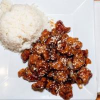 Sesame Chicken · Breaded white meat chicken, stir fried in a sweet tangy sauce with sauteed onions, topped wi...