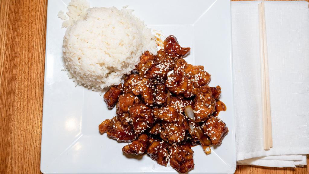 Sesame Chicken · Breaded white meat chicken, stir fried in a sweet tangy sauce with sauteed onions, topped with sesame seed and green onions.