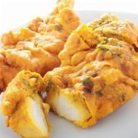 Chicken Pakora · Thinly chopped chicken and onion dipped in a spiced chickpea flour batter and fried.