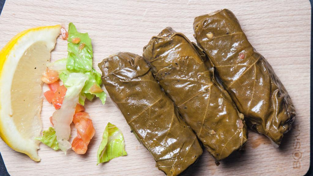 Stuffed Grape Leaves · Vegan. Three pieces. Three grape leaves stuffed with rice, chopped parsley, onion, tomatoes, bell pepper and a blend of lavash spices, rolled and slowly cooked to perfection.