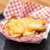 Mike'S Bites · Sliced potatoes, fried and served with Merkt's Cheddar and grated Parmesan cheese