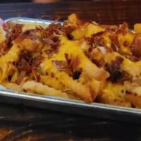 Loaded Fries · Our hand-cut fries smothered in-house country gravy, shredded cheese, and bacon.