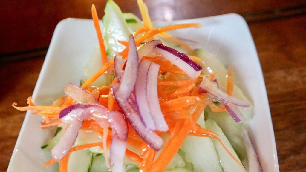 Cucumber Salad · Fresh cucumber, carrot, red onions with light sweet and sour dressing.