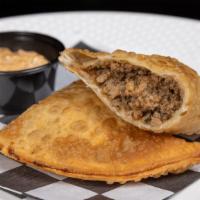 Meat Pie · Flaky homemade pastry puff filled with ground pork and beef, green onion, garlic, creole spi...