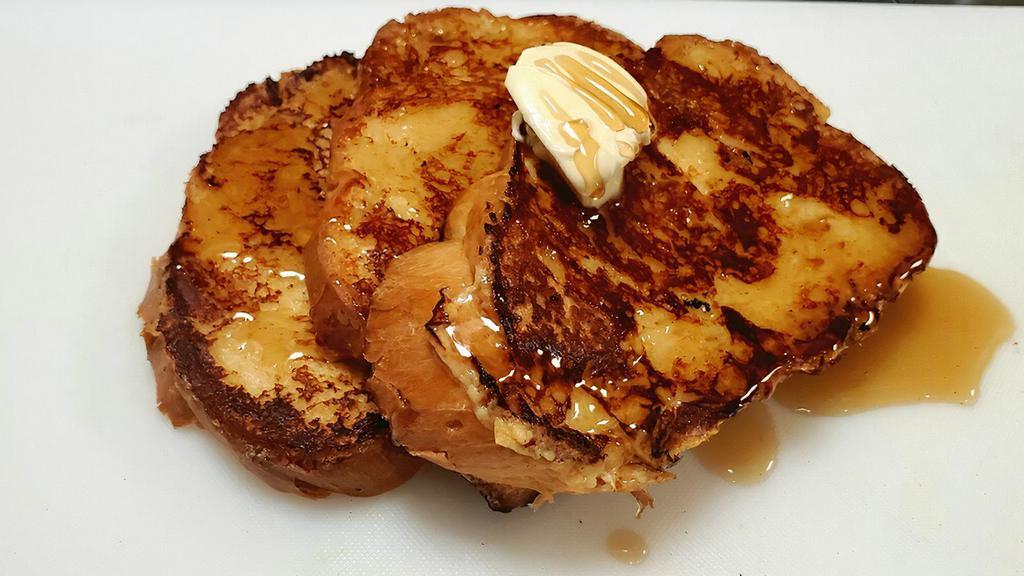 French Toast · House made challah bread dipped in a fresh made mix with a side of maple syrup and butter.(Fruit NOT included)