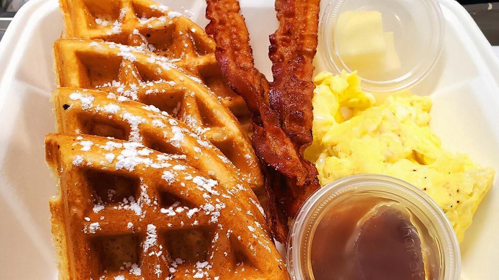 Waffle Deluxe · Belgian style waffle with side of maple syrup and butter, scrambled eggs and your choice of meat