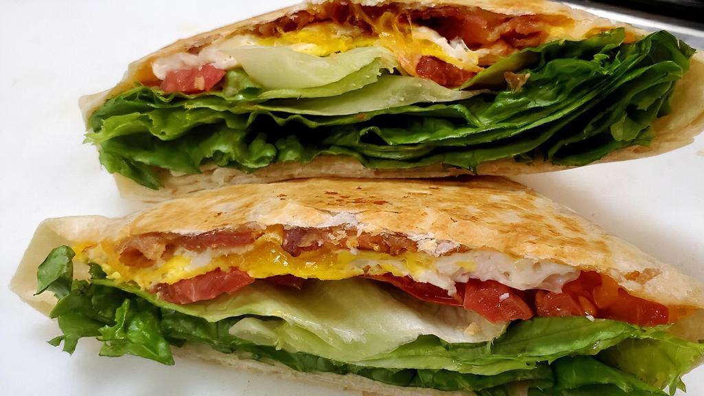 Belt Pocket · Bacon, fried eggs, lettuce, tomato, cheddar cheese and sriracha mayo on a flour tortilla.