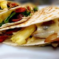 Breakfast Quesadilla · Spinach, bell peppers, onions, eggs, bacon, Chihuahua cheese, with a side of mild salsa on a...