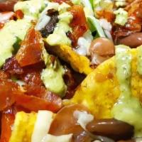 Nachos Supreme · Corn chips, chihuahua cheese, beans, bacon, bell peppers, tomatoes, mushrooms topped with a ...