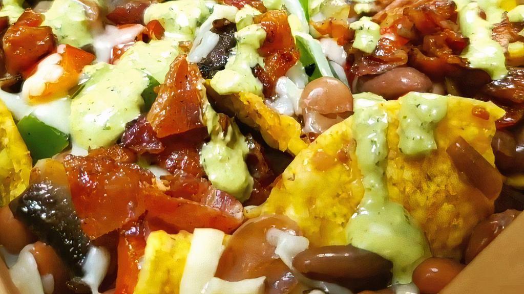 Nachos Supreme · Corn chips, chihuahua cheese, beans, bacon, bell peppers, tomatoes, mushrooms topped with a creamy cilantro dressing