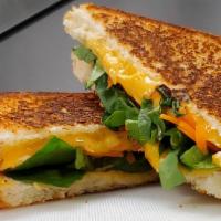 Mex Grilled Cheese · A blend of cheese , carrots and spinach on a golden grilled white bread