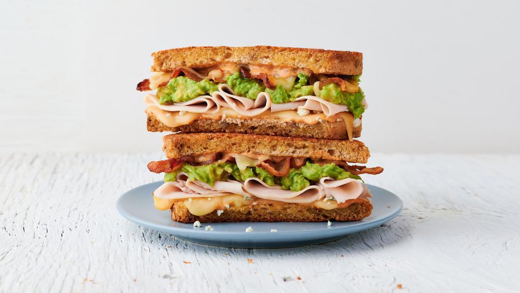 The Thursday · Roasted turkey, bacon, muenster cheese, blue cheese crumbles, avocado spread & Society Sauce on choice of bread