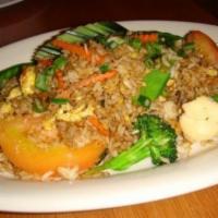 #55 Thai Fried Rice · Rice stir-fried with black soy sauce, egg, spices & green onions. Tomato & sliced cucumber
