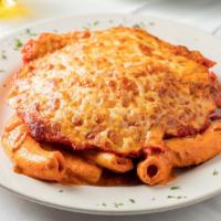 Homemade Rigatoni With Chicken Parmigiana  · Homemade rigatoni pasta with chicken parmigiana on top in a creamy bolognese sauce