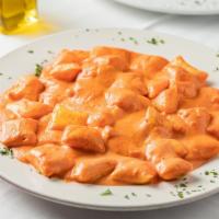 Homemade Gnocchi Stuffed With Asiago Cheese In A Creamy Tomato Sauce  · Homemade gnocchi stuffed with asiago cheese in a creamy tomato sauce