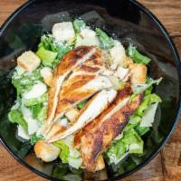 Caesar Salad · Crispy romaine lettuce, grilled chicken breast, croutons, Parmesan cheese, with a side of ou...