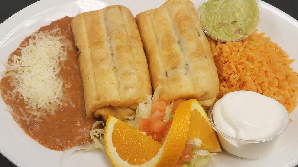 Tu Casa Chimichangas · Two deep fried flour tortillas filled with cheese and your choice of chicken, ground beef, steak or pastor. Served with sour cream and guacamole.