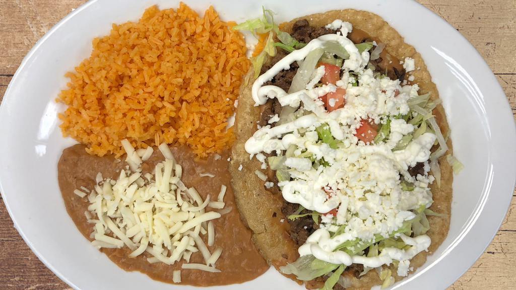 Huarache · Deep fried corn dough with your choice of chicken, steak, pork or ground beef topped with lettuce tomatoes, queso fresco and sour cream.
