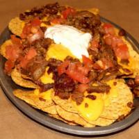 Nachos Supreme · Served with nachos chips ,cheddar cheese, tomato, sour cream, & your choice of meat. Feeds 2...