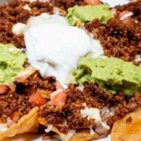 Nachos Rancho Grande · Served with home made chips beans, melted cheese, guacamole, tomato, & sour cream. Feed 2-3 ...