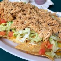 Southwest Nachos · Fresh tortilla chips topped with spicy shredded chicken, cheese sauce, lettuce and tomatoes....