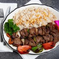 Shish Kabob · Choice of lamb or beef, skewered charbroiled tender chunks of meat with onions and green pep...