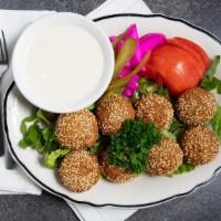 Falafel Plate (8 Pc) · All vegetable patties served with lettuce, tomatoes, pickles and tahini (sesame seed) sauce.