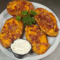 Potato Skins · Piled high with cheddar and bacon, served with sour cream.
