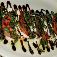 Caprese Salad · Vine ripened tomatoes with fresh mozzarella, basil, olive oil, topped with homemade pesto an...