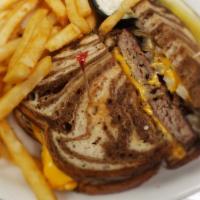 Patty Melt · A lean half pound burger topped with American cheese and grilled onions, served on grilled r...