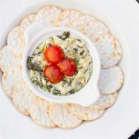 When I Dip · Creamy tri-cheese blend with roasted artichokes, spinach, and garlic served with lavash chips.