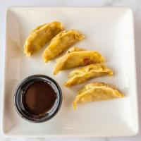 Chicken Pot Stickers · Potstickers seared with an Asian dipping sauce.