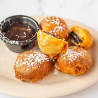Fried Oreos · Four oreo cookies deep fried and served with hershey's hot fudge.