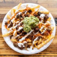 Carne-Asada Fries · Carne asada, cheese, hot sauce, guacamole and sour cream on a bed of fries
