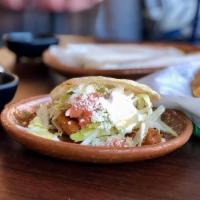 2 Grilled Gorditas · A Mexican pastry made with masa.  Filled with your choice of meat, topped with lettuce, toma...