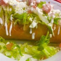 Chimichanga Plate · Chimichanga with your choice of meat, topped with lettuce, tomato, cheese, and sour cream.