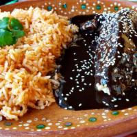 Mole Con Pollo · Mildly spicy, served with shredded chicken, Rice and side of corn tortillas