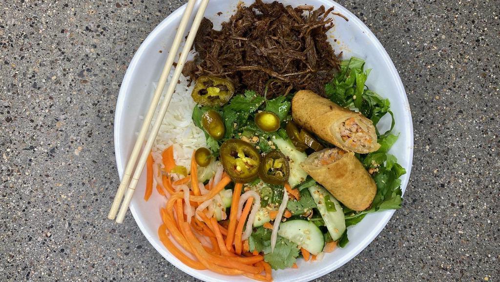 Barbacoa Bowl (Pulled Beef) · Vietnamese style seasoned Beef slow-cooked for hours to delivery smoky juicy pulled beef serve with noodles, mixed greens, pickled carrots & daikon, cucumber, cilantros, Jalapeños, scallions, and tacos sauce.