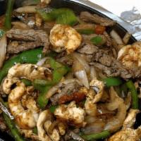 La Campesina Fajita · Tender beef, chicken, shrimp cooked with onions, tomatoes and bell peppers. Served with frie...