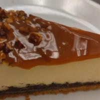 Turtle Cheesecake · A Gourmet New York style cheesecake garnished with caramel sauce and pecan.