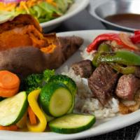 Sirloin Beef Tips · Served on a bed of rice with grilled onions, peppers and mushroom gravy.