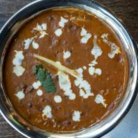 Dal Makhani · Black lentils prepared with tomatoes, onions, garlic, and ginger, cooked on a slow fire.