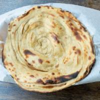 Paratha · A multi-layered whole wheat bread made with butter, baked in the clay oven.