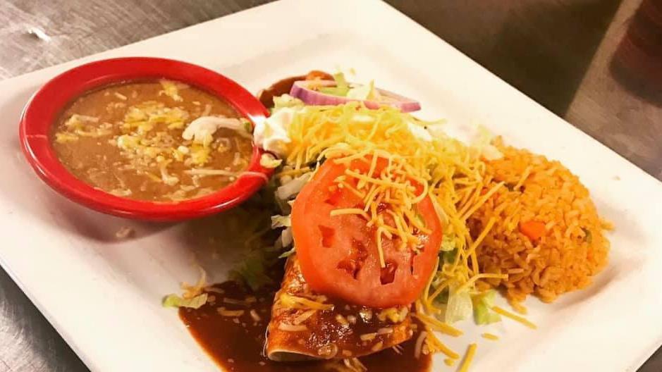 Burrito La Cascada · A flour tortilla stuffed with your choice of seasoned ground beef or shredded chicken. Topped with burrito sauce, lettuce, sour cream, tomatoes and cheese and served with rice and beans.