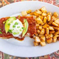 Breakfast Enchiladas · Com tortillas stuffed with eggs, chorizo, peppers, onions cheddar, topped with ranchero, sou...